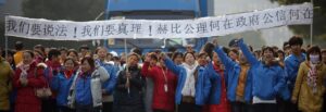 Workers on strike blocking the entrance gate of Hi-P International factory yell slogans during a protest in Shanghai